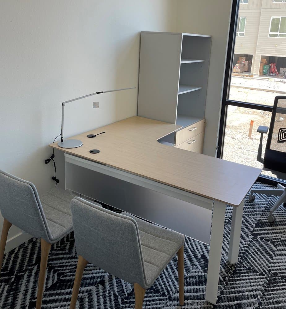 An L-shaped desk with drawers and shelves